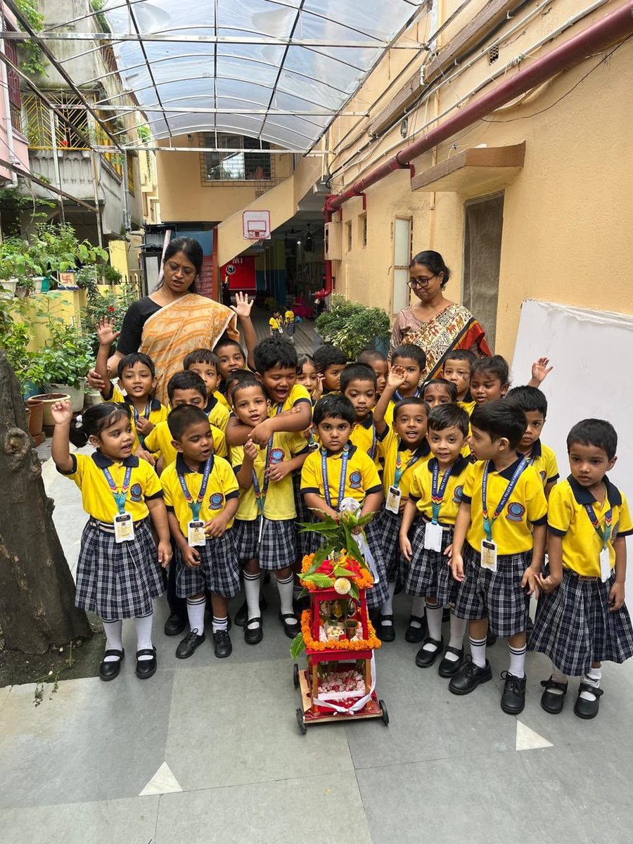 Children and teachers gathered joyfully in the Holy Montessori garden