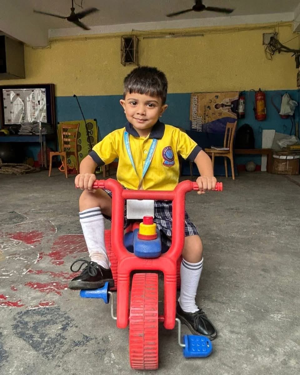 Riding the red tricycle in the play hall